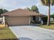 Charming home featuring a stone facade, a spacious driveway, and a well-maintained yard at 21511 Sw Plantation Sw St, Dunnellon, FL 34431