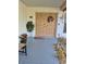 Inviting front door adorned with wreath, plants, and decorative accents at 21511 Sw Plantation Sw St, Dunnellon, FL 34431