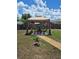 Charming backyard gazebo with seating, decorative details, and pea gravel walkway, ideal for outdoor gatherings at 21511 Sw Plantation Sw St, Dunnellon, FL 34431