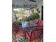 A covered patio features a glass table surrounded by red cushioned chairs and a decorative rug at 21511 Sw Plantation Sw St, Dunnellon, FL 34431