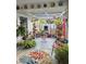 An outdoor patio filled with lush plants and colorful decor creates a relaxing, vibrant space at 21511 Sw Plantation Sw St, Dunnellon, FL 34431