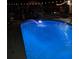 Beautiful in-ground swimming pool illuminated at night at 21511 Sw Plantation Sw St, Dunnellon, FL 34431