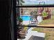 View of a sparkling swimming pool and beautiful backyard from inside the home at 21511 Sw Plantation Sw St, Dunnellon, FL 34431