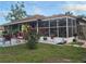 This home boasts a spacious screened porch, perfect for enjoying the outdoors at 21511 Sw Plantation Sw St, Dunnellon, FL 34431