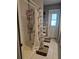 Bathroom shower with white tile, shower caddy, patterned shower curtain and exit door at 21511 Sw Plantation Sw St, Dunnellon, FL 34431