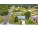 An aerial view of a residential neighborhood with tree lined streets and a single story home with gray roof in foreground at 226 Locust Ln, Ocala, FL 34472