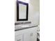 Bathroom features a granite countertop, undermount sink, chrome faucet, and a black framed mirror at 226 Locust Ln, Ocala, FL 34472