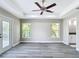 A view of the bedroom showing two windows and French doors to the backyard and entry to the bathroom at 226 Locust Ln, Ocala, FL 34472