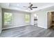Bedroom featuring gray wood-look floors, ceiling fan, recessed lighting, and ensuite bathroom at 226 Locust Ln, Ocala, FL 34472