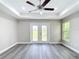 Bedroom featuring gray wood-look floors, ceiling fan, recessed lighting, and french doors to the backyard at 226 Locust Ln, Ocala, FL 34472