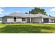 Charming single-story home with a well-manicured lawn and a gray roof at 226 Locust Ln, Ocala, FL 34472