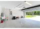 A large two car garage features a utility sink, water heater, and an open garage door to the outside at 226 Locust Ln, Ocala, FL 34472