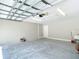 Open two-car garage with painted walls, finished concrete floor, and utility sink ready for projects at 226 Locust Ln, Ocala, FL 34472
