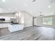Open floor plan of the kitchen with white cabinetry, gray counter tops and island at 226 Locust Ln, Ocala, FL 34472