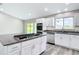 Spacious kitchen featuring white cabinets, granite countertops, and a center island cooktop at 226 Locust Ln, Ocala, FL 34472