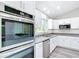 Close-up of a kitchen with white cabinets, stainless steel appliances, and granite countertops at 226 Locust Ln, Ocala, FL 34472