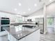 Modern kitchen with white cabinetry, stainless steel appliances, and granite countertops at 226 Locust Ln, Ocala, FL 34472