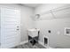 Laundry room featuring a utility sink, door to the exterior, and a shelf at 226 Locust Ln, Ocala, FL 34472