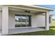 Enjoy outdoor living with this covered patio and ceiling fan, perfect for relaxing and entertaining at 226 Locust Ln, Ocala, FL 34472