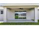Covered patio features a ceiling fan and sliding glass doors to the home's interior at 226 Locust Ln, Ocala, FL 34472