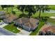 Aerial view of home in a golf course community, lush green landscaping and mature trees at 2515 Nw 53 Ave, Ocala, FL 34482