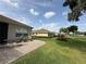 Scenic backyard with a brick patio, green lawn, and view of adjacent homes and manicured landscaping at 2515 Nw 53 Ave, Ocala, FL 34482