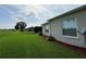 Well-maintained backyard featuring lush green grass, mulch beds, and an exterior view of the home at 2515 Nw 53 Ave, Ocala, FL 34482