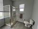 A modern bathroom featuring a glass shower, toilet, towel rack, and natural light at 2515 Nw 53 Ave, Ocala, FL 34482