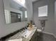 Bathroom featuring a granite countertop, modern fixtures, and a shower with sliding glass doors at 2515 Nw 53 Ave, Ocala, FL 34482