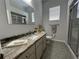 Bathroom featuring granite countertops, modern fixtures, tiled floors, and a shower with sliding glass doors at 2515 Nw 53 Ave, Ocala, FL 34482