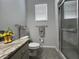 Bathroom featuring a shower with glass doors, tiled floors, and modern towel racks at 2515 Nw 53 Ave, Ocala, FL 34482