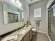 Bathroom featuring granite countertops, modern fixtures, tiled floors, and a shower with sliding glass doors at 2515 Nw 53 Ave, Ocala, FL 34482
