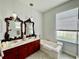 Soaking tub in elegant bathroom with dual vanity, marble countertop, and ornate mirrors at 2515 Nw 53 Ave, Ocala, FL 34482