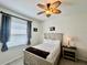 Bright bedroom with modern ceiling fan, matching side table and dresser, and natural light at 2515 Nw 53 Ave, Ocala, FL 34482
