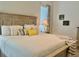 Bedroom with large bed, neutral tones, tile flooring, natural light, and stylish decor at 2515 Nw 53 Ave, Ocala, FL 34482