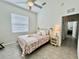 Cozy bedroom features a comfortable bed, nightstand, and decor, illuminated by natural light from the window at 2515 Nw 53 Ave, Ocala, FL 34482