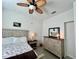 Bright bedroom with modern ceiling fan, matching side table and dresser, and natural light at 2515 Nw 53 Ave, Ocala, FL 34482