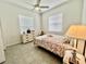 Bedroom featuring tiled floors, a dresser, and a bed for a comfortable space at 2515 Nw 53 Ave, Ocala, FL 34482