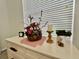 Well decorated white dresser featuring flowers, a candle, and a clock at 2515 Nw 53 Ave, Ocala, FL 34482