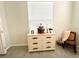 Dresser with decor and a window, next to a rocking chair and tiled floors at 2515 Nw 53 Ave, Ocala, FL 34482