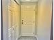 Front entrance showcasing a white front door next to a storage closet at 2515 Nw 53 Ave, Ocala, FL 34482