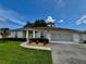 Inviting single-story home with well-kept lawn, tidy flowerbeds, and attached two-car garage, perfect for suburban living at 2515 Nw 53 Ave, Ocala, FL 34482