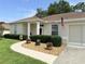 Charming home featuring a well-manicured front yard, inviting pathway and an American flag at 2515 Nw 53 Ave, Ocala, FL 34482
