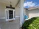 Cozy front porch featuring a welcome mat, exterior lights, and a bright blue Adirondack chair at 2515 Nw 53 Ave, Ocala, FL 34482