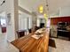 The kitchen island acts as a breakfast bar with view of the kitchen and living room at 2515 Nw 53 Ave, Ocala, FL 34482