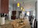 View of a kitchen island and sink with a view of the open-concept floor plan at 2515 Nw 53 Ave, Ocala, FL 34482