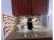 The kitchen countertop includes a coffee station with dark wood cabinets and decorative tile backsplash at 2515 Nw 53 Ave, Ocala, FL 34482