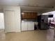 Large laundry room featuring a stainless steel refrigerator and washer/dryer set at 2515 Nw 53 Ave, Ocala, FL 34482