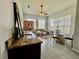 Living room featuring a bar, tile floors, stylish furnishings, a ceiling fan, and natural light from windows at 2515 Nw 53 Ave, Ocala, FL 34482