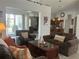 Open-concept living room featuring comfortable furniture and a view into kitchen at 2515 Nw 53 Ave, Ocala, FL 34482